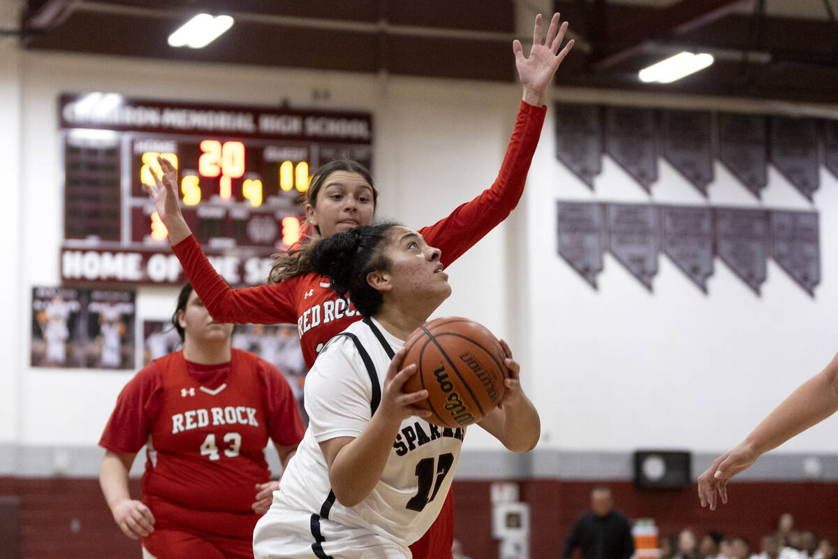 Cimarron-Memorial’s Chloe Ricketts (12) shoots while Doral’s Peyton Gomez, behind ...