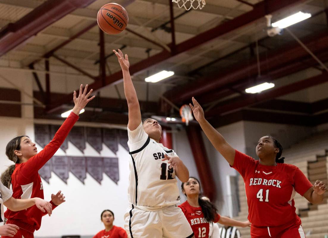 Cimarron-Memorial’s Chloe Ricketts (12) shoots against Doral’s Peyton Gomez, left ...