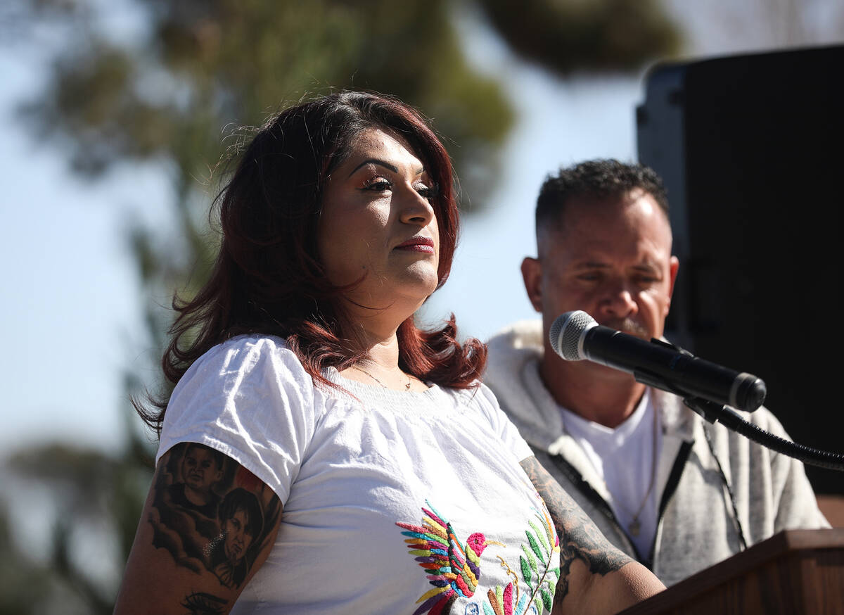 Erlinda Zacarias addresses a crowd next to her husband Jesus Mejia-Santana at a tree dedication ...
