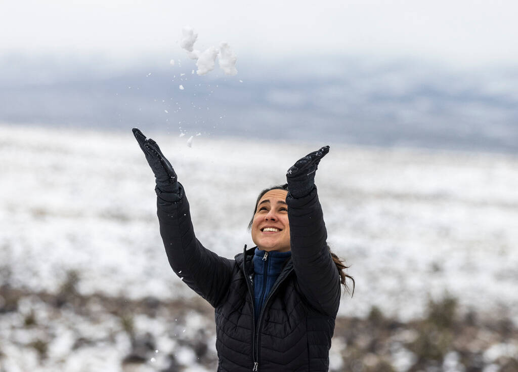 A tourist, who declined to give her name, throws snow in the air at the Red Rock Canyon overloo ...