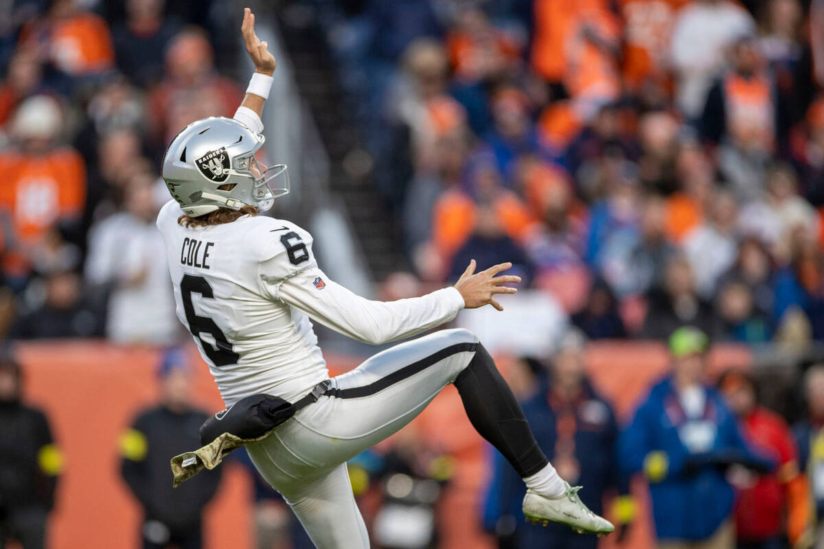 Raiders punter AJ Cole (6) watches his punt during the second half of an NFL game against the D ...