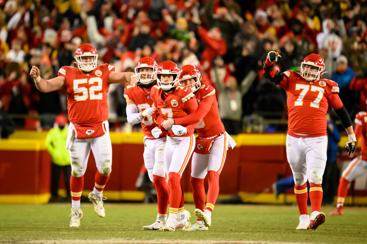 Kansas City Chiefs place kicker Harrison Butker (7) is hugged by Chiefs punter Tommy Townsend a ...