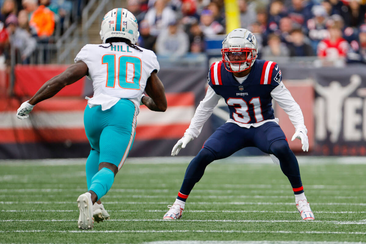 Miami Dolphins wide receiver Tyreek Hill (10) is defended by New England Patriots cornerback Jo ...
