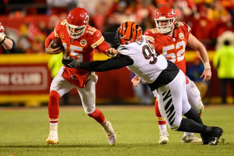 Kansas City Chiefs quarterback Patrick Mahomes (15) is tackled by Cincinnati Bengals defensive ...