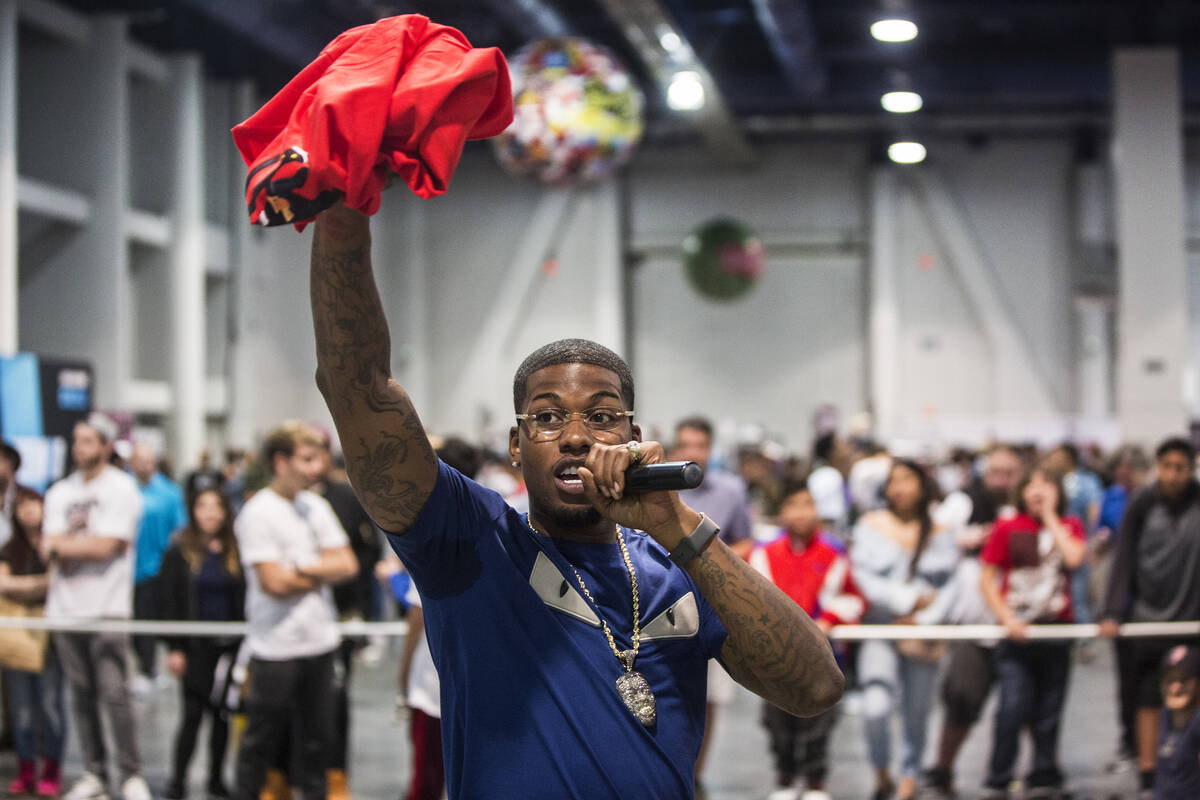 Cordero Brady, aka "CJ so Cool" hands out free tee shirts during Sneaker Con at the Las Vegas C ...