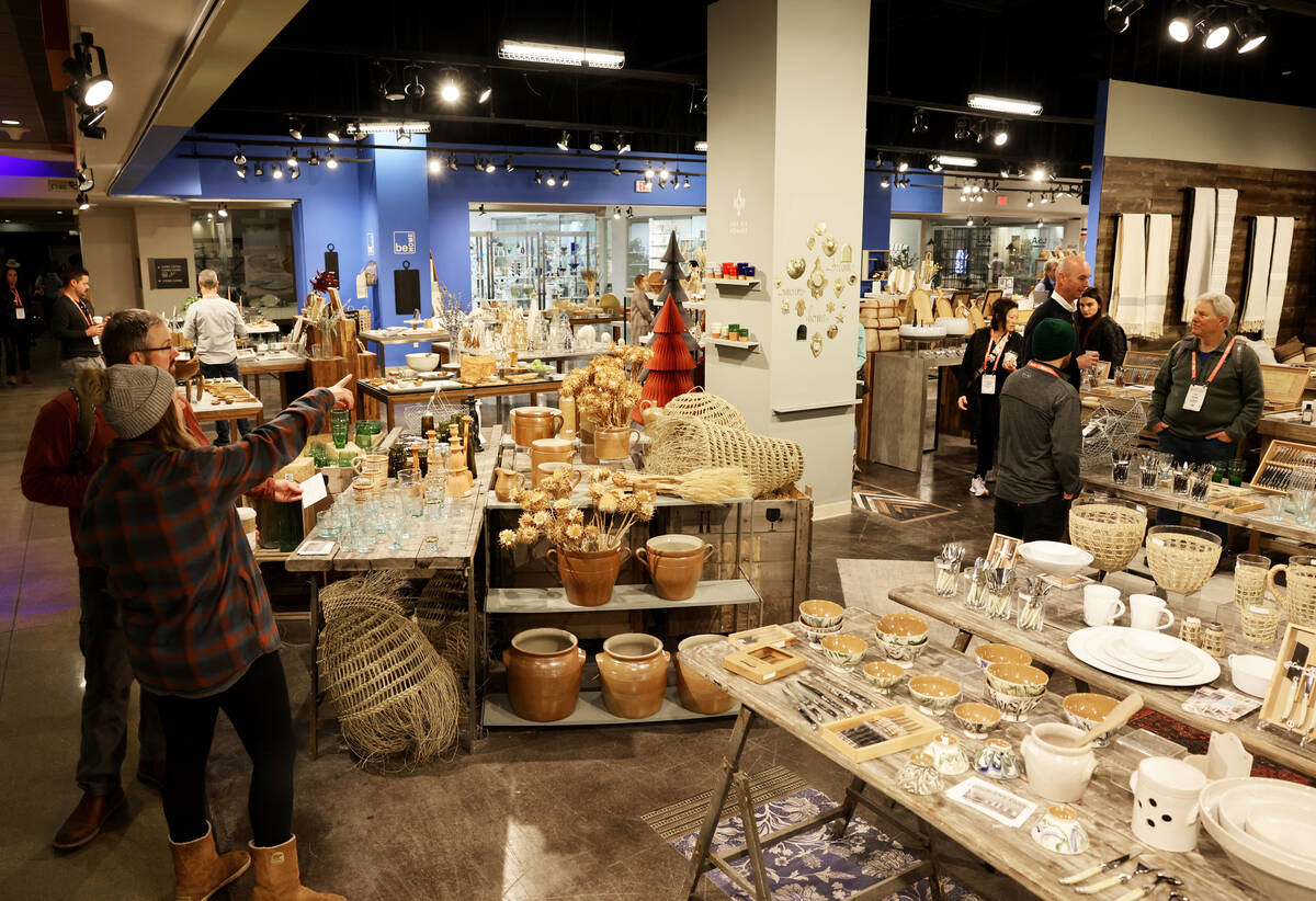 Conventioneers browse in the Kiss That Frog housewares and Be Home home goods showrooms during ...