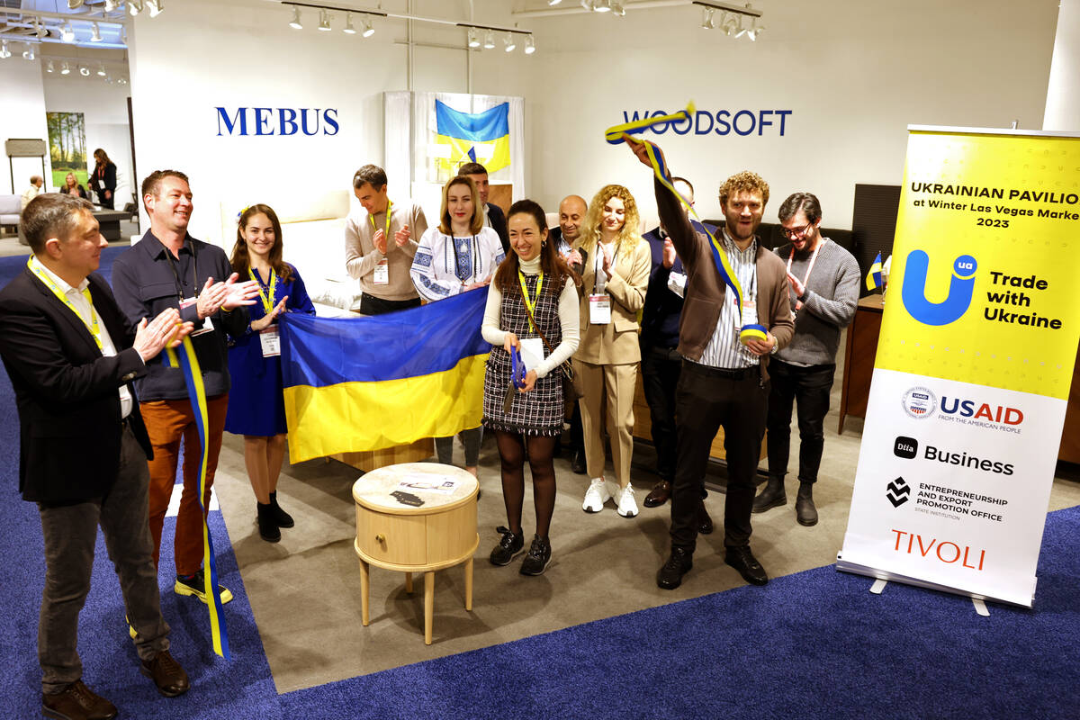 Conventioneers celebrate cutting the ribbon in the Ukrainian Pavilion during the biannual Las V ...