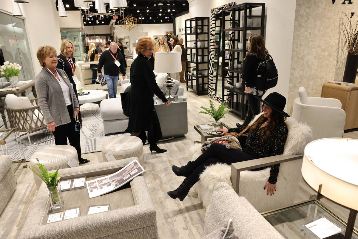Lisa Bakamis of South Lake Tahoe, Calif. tries a furry chair in the Vanguard Furniture Company ...