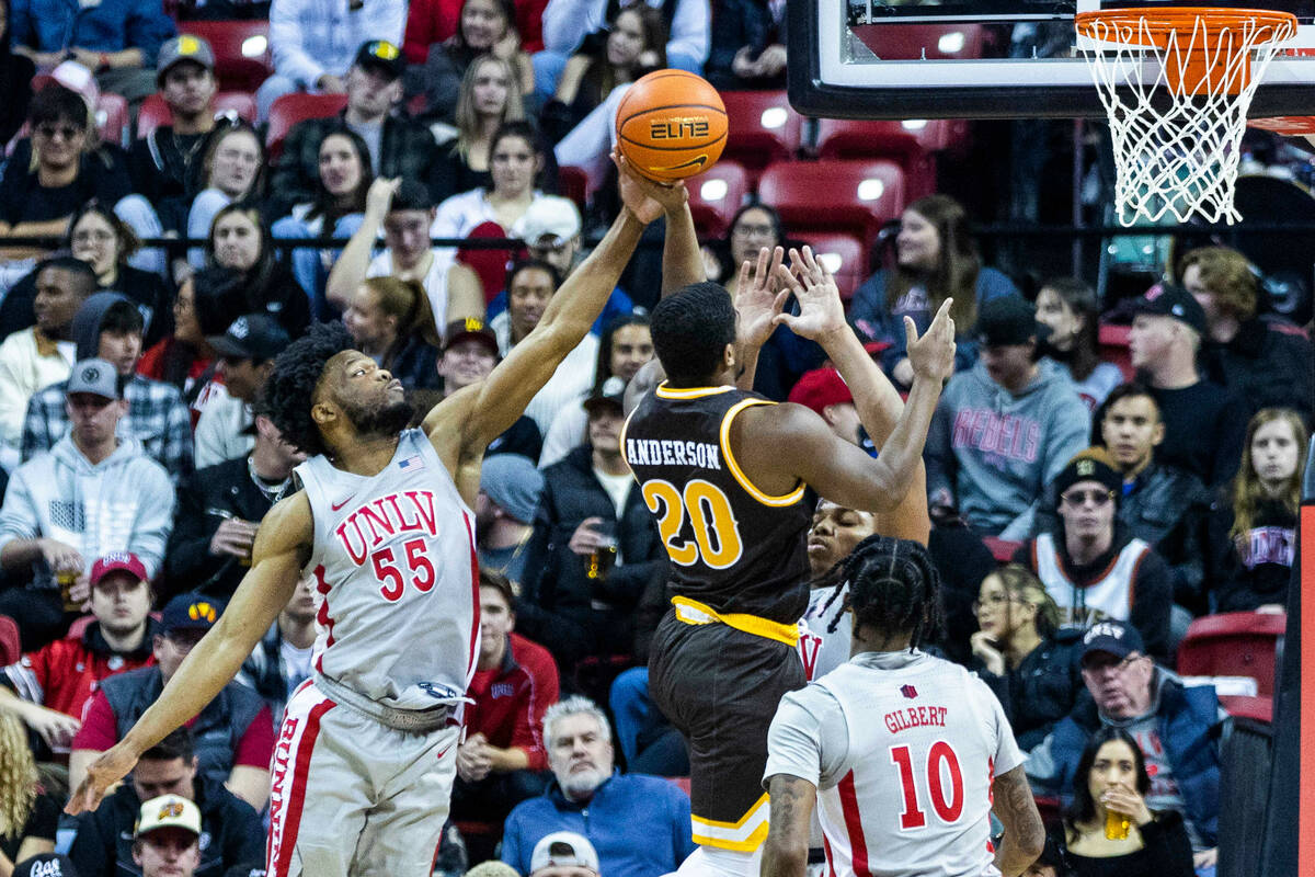 UNLV guard EJ Harkless (55) blocks a shot attempt by Wyoming guard Ethan Anderson (20) during t ...