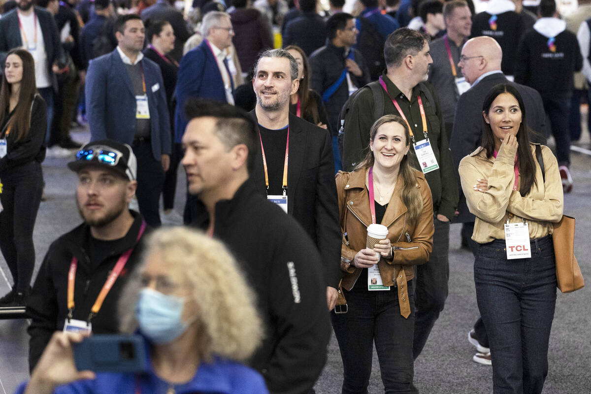 Attendees marvel at booths during the CES tech show at the Las Vegas Convention Center on Satur ...