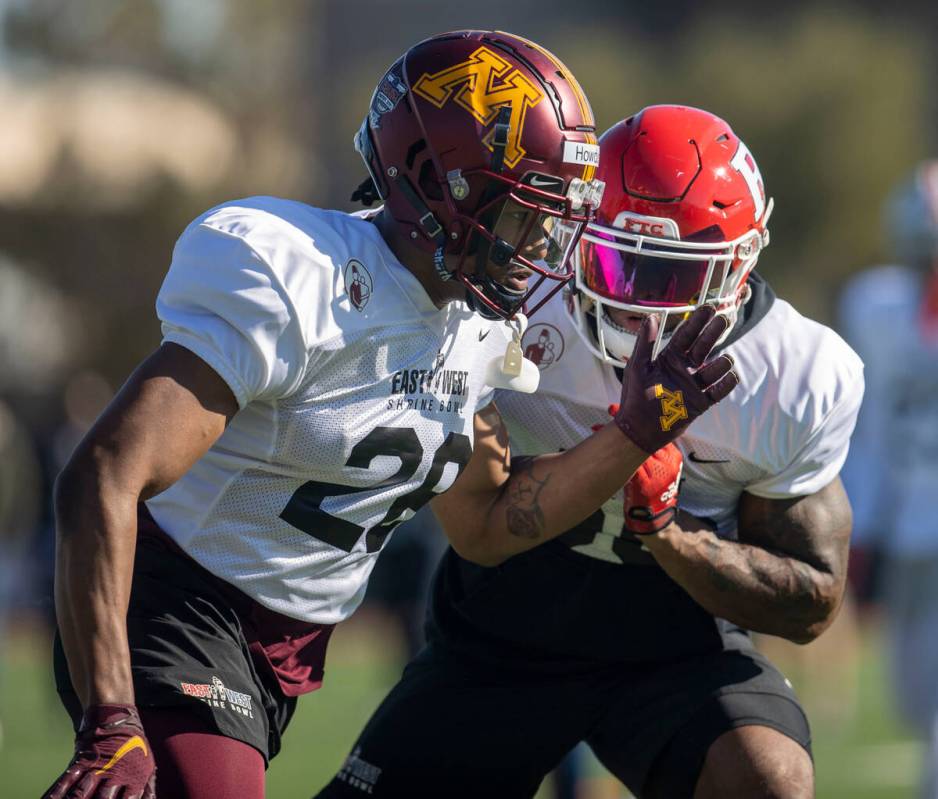 West safety Jordan Howden (28) works past West safety Christian Izien (30) during practice for ...