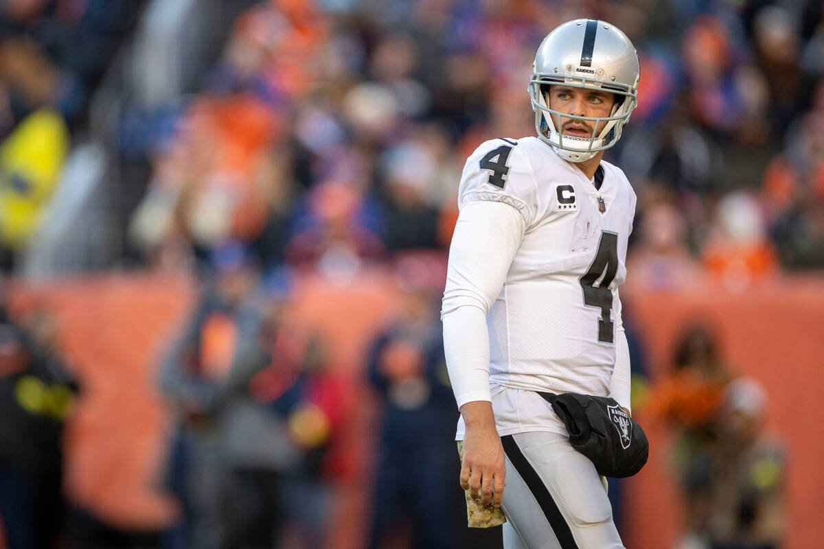 Raiders quarterback Derek Carr (4) walks the field during the first half of an NFL game against ...