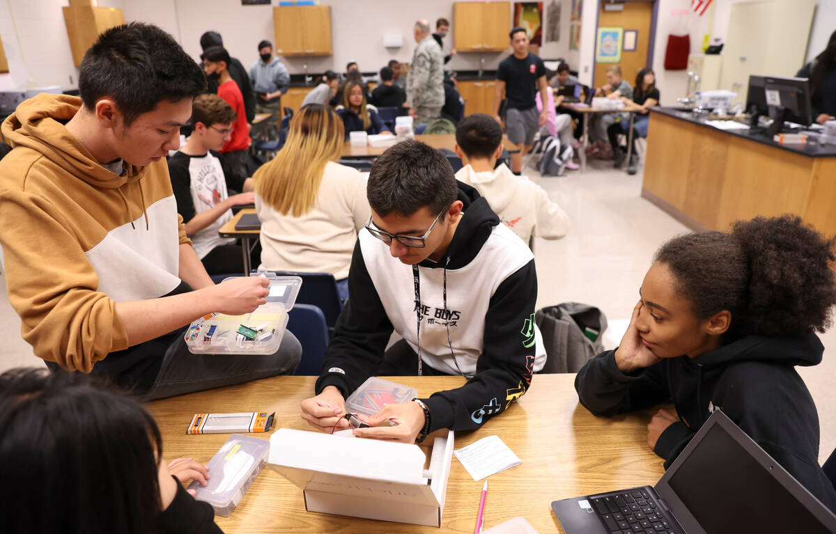 From left, senior James Phan, sophomore Keoni Johnson and sophomore Princess Hackett work with ...