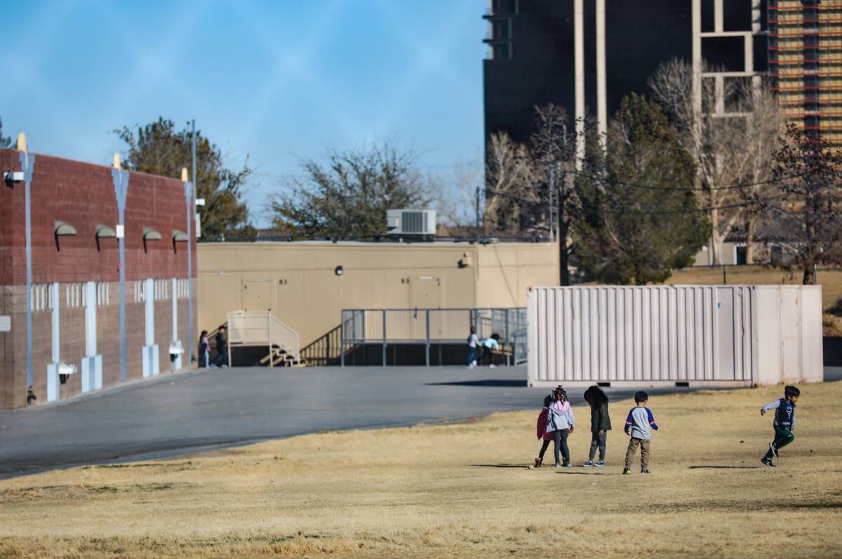 Children play in the field at Wayne N. Tanaka Elementary School in Las Vegas, Tuesday, Jan. 31, ...