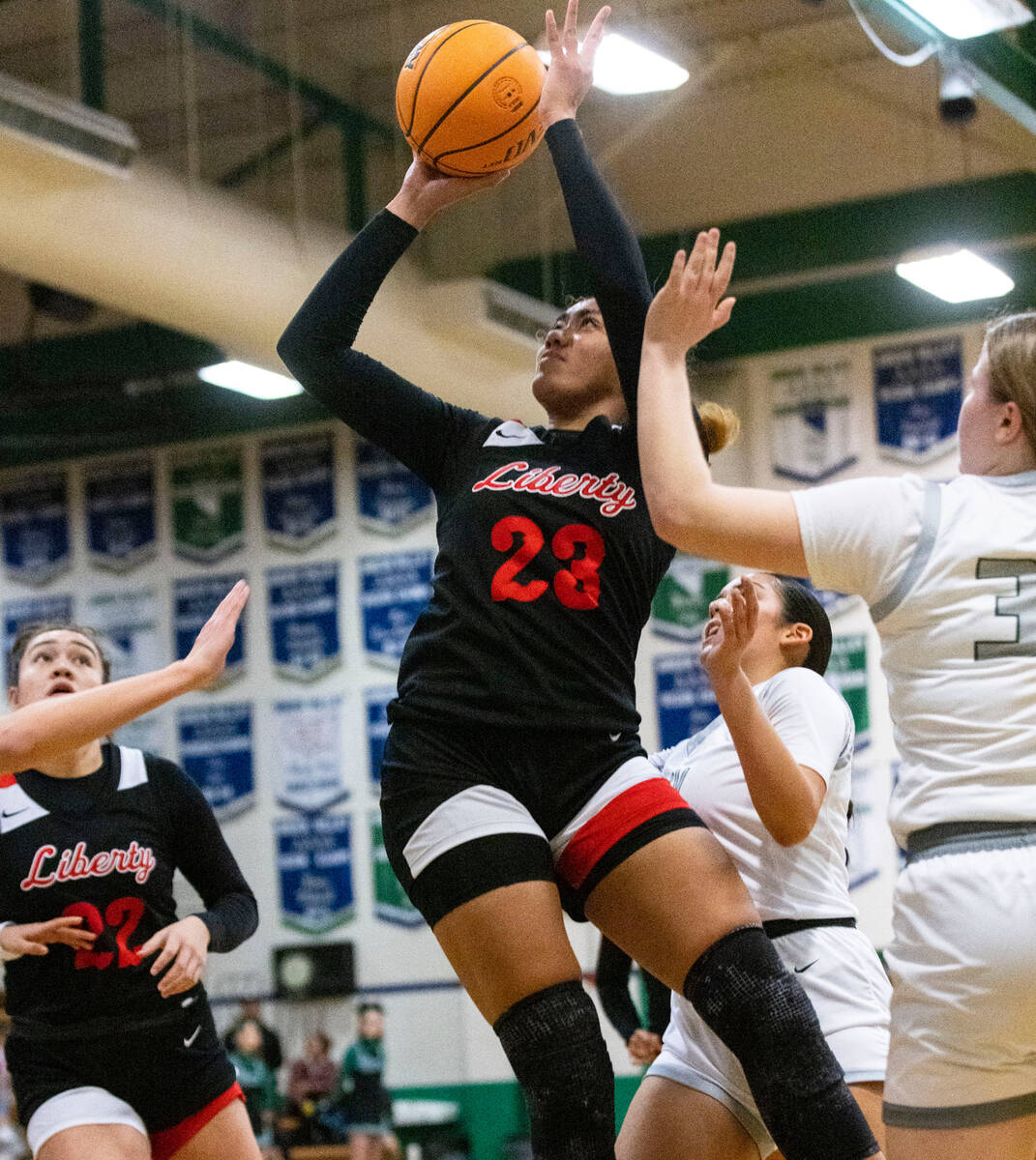 Liberty High's Adrienne Puletasi (23) shoots over Green Valley High's Amelia Rawhouser (30) dur ...