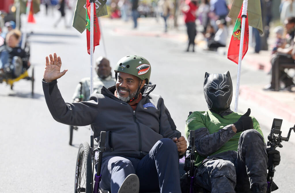 Rep. Steven Horsford, D-Nev., rides in the Forgotten Not Gone entry during the Veterans Day par ...