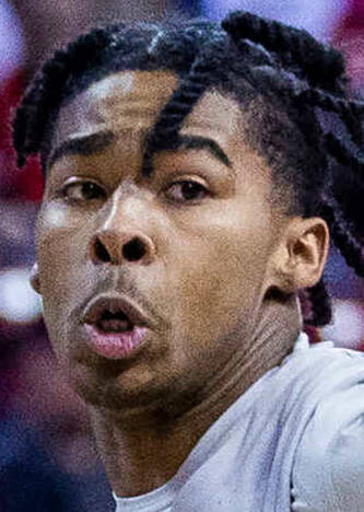 UNLV guard Keshon Gilbert (10) looks to drive past Wyoming guard Hunter Maldonado (24) during t ...