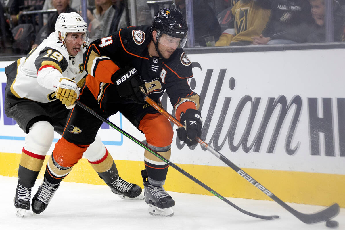 Golden Knights right wing Reilly Smith (19) and Ducks defenseman Cam Fowler (4) compete for the ...