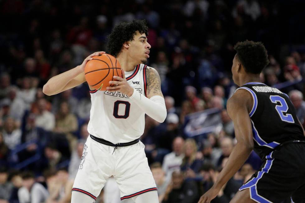 Gonzaga guard Julian Strawther (0) controls the ball while defended by BYU guard Jaxson Robinso ...