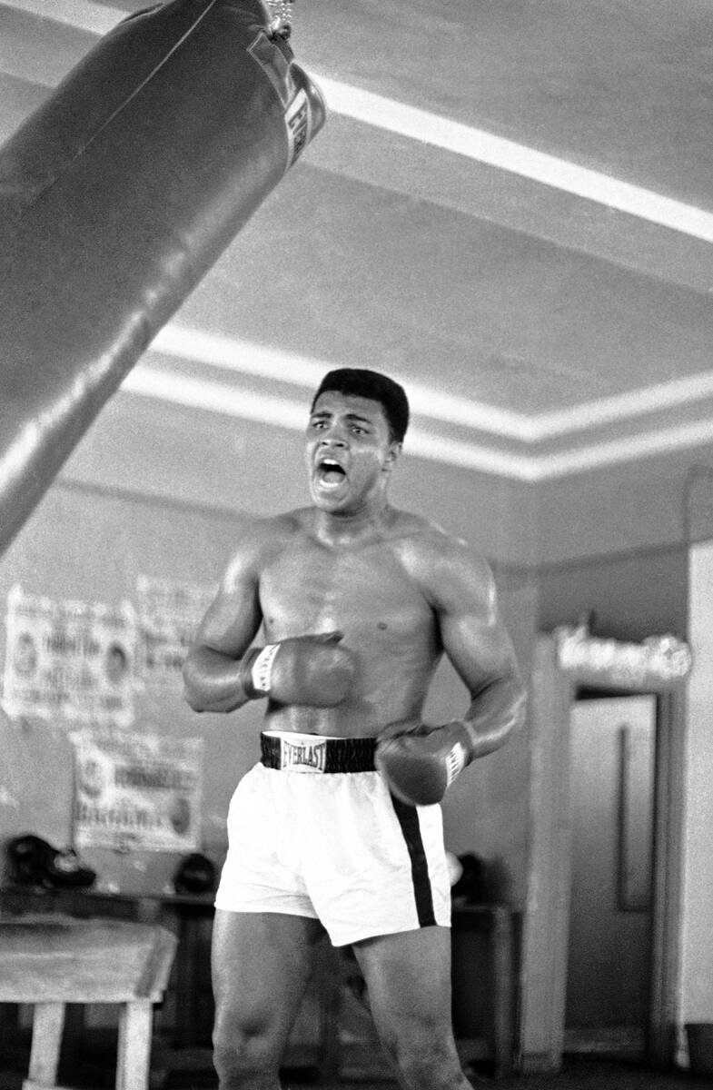 Muhammad Ali (Cassius Clay) punches the heavy bag in one of his daily workouts at Miami Beach f ...