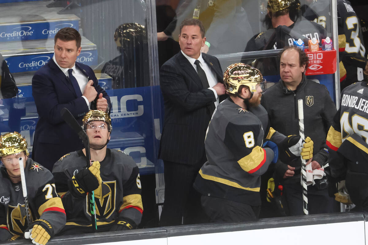 Golden Knights head coach Bruce Cassidy, center, looks on at the end of the first period of an ...