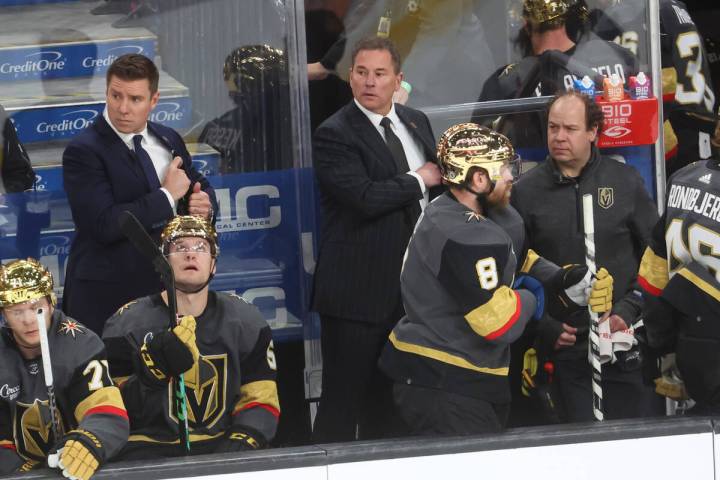 Golden Knights head coach Bruce Cassidy, center, looks on at the end of the first period of an ...