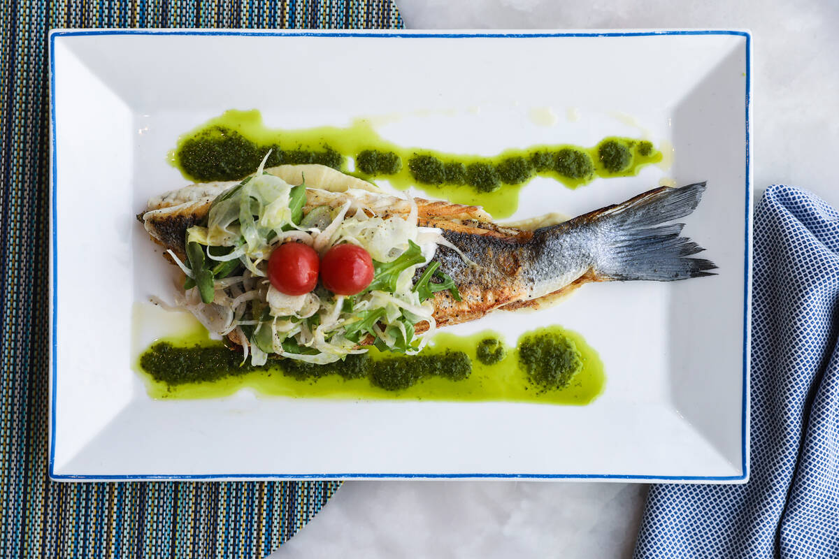 The grilled branzino dish with capers, olives, tomatoes, and romanesco cauliflower florets at L ...