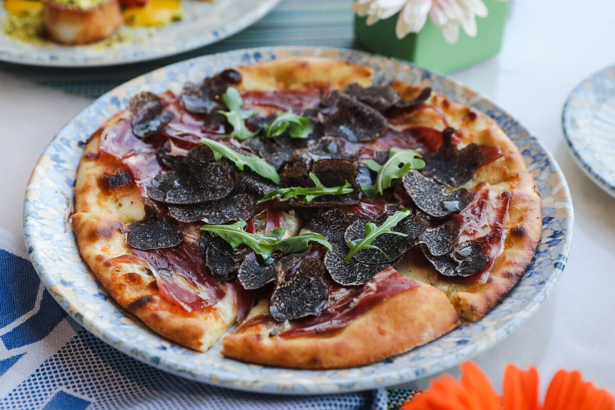 The Lago pizzetta with black truffle shavings, pata negra, and truffle cheese at the Bellagio i ...