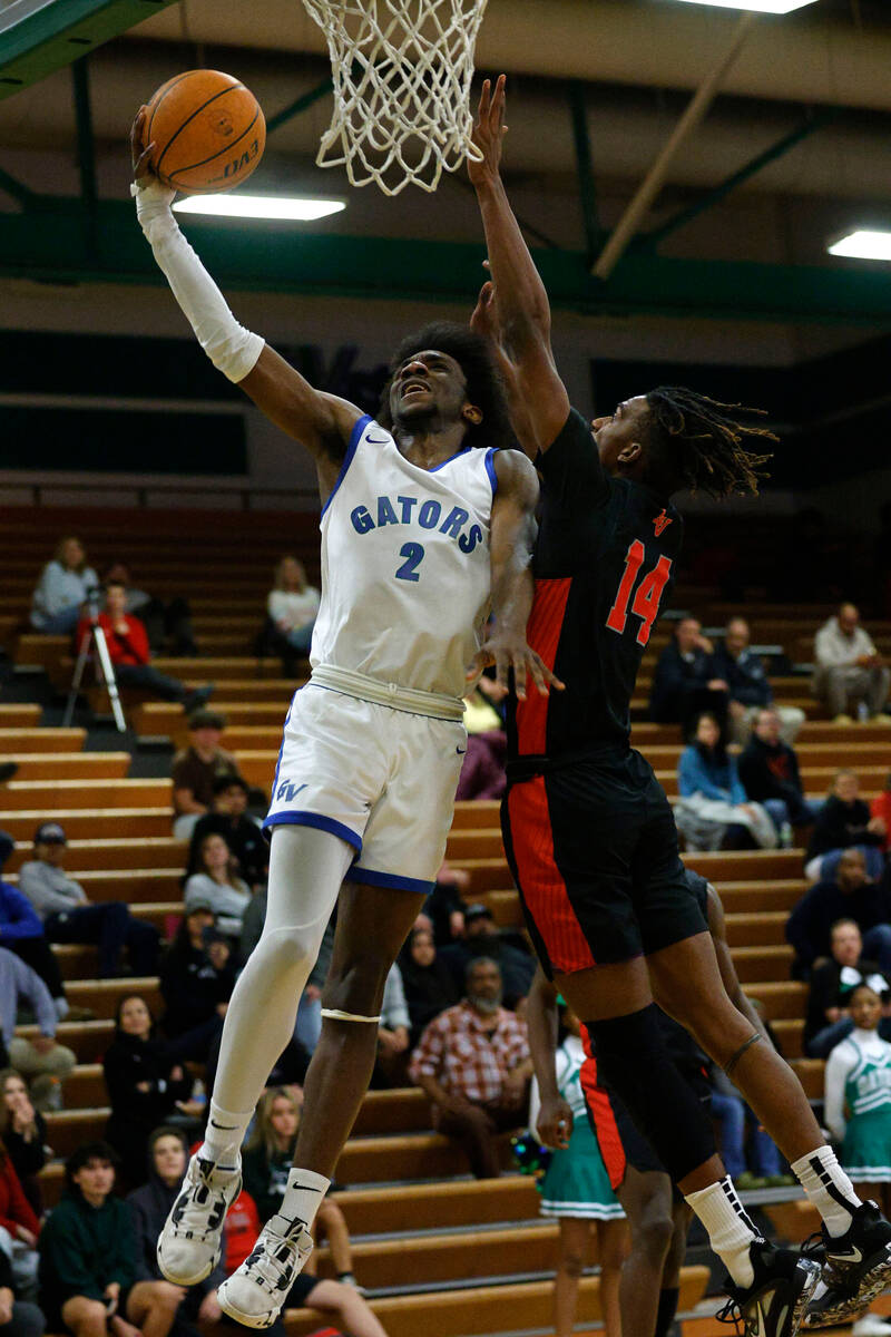Green Valley's Scott Hammond (2) goes to the basket as Las Vegas' Bryce Davis (14) defends duri ...