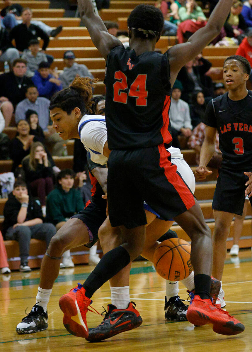 Green Valley's Gaston Zumaya (3) loses a ball as Las Vegas' Jordan Stevens (24) defends during ...