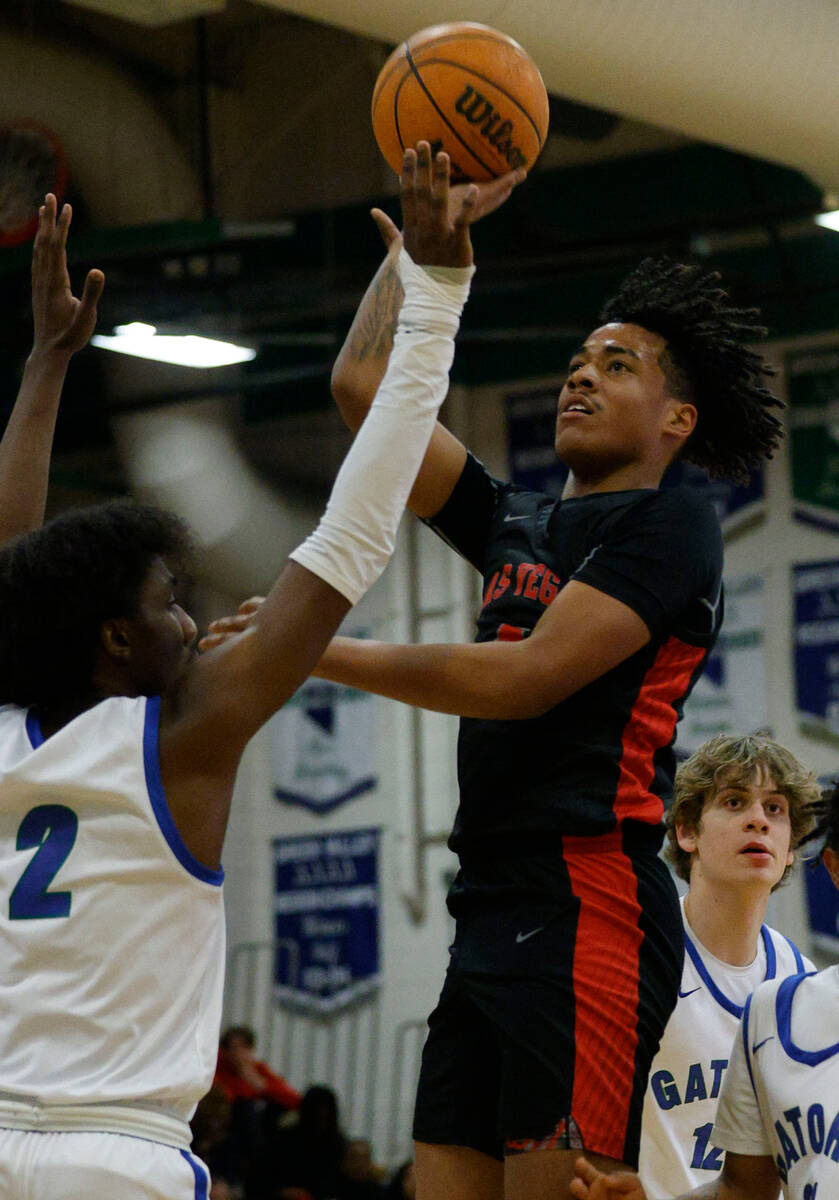 Las Vegas' Marcus Gomez (4) shoots over Green Valley's Scott Hammond (2) during the first half ...