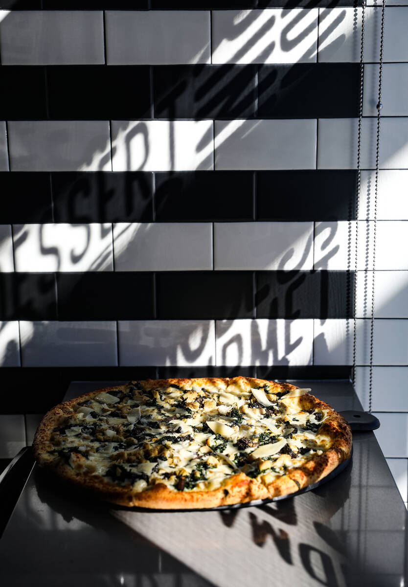 The Roux pizza pie, made of white sauce, chicken, spinach, mushrooms, garlic, mozzarella cheese ...