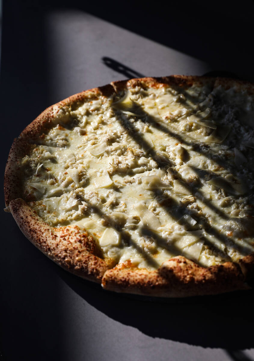 The crab pizza pie made of white sauce, crab meat, garlic, mozzarella and Parmesan cheese at Cr ...