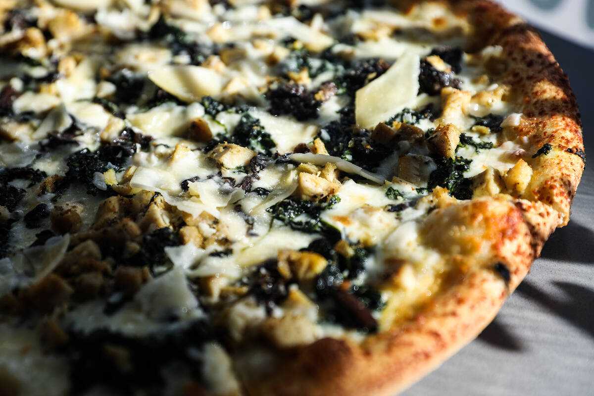 The Roux pizza pie, made of white sauce, chicken, spinach, mushrooms, garlic, mozzarella cheese ...