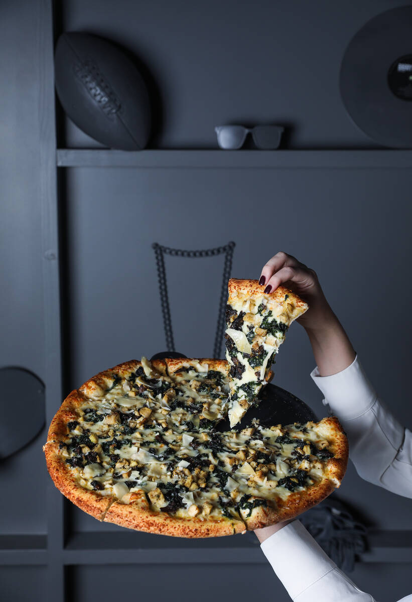 The Roux pizza pie, made of white sauce, chicken, spinach, mushrooms, garlic, mozzarella cheese ...