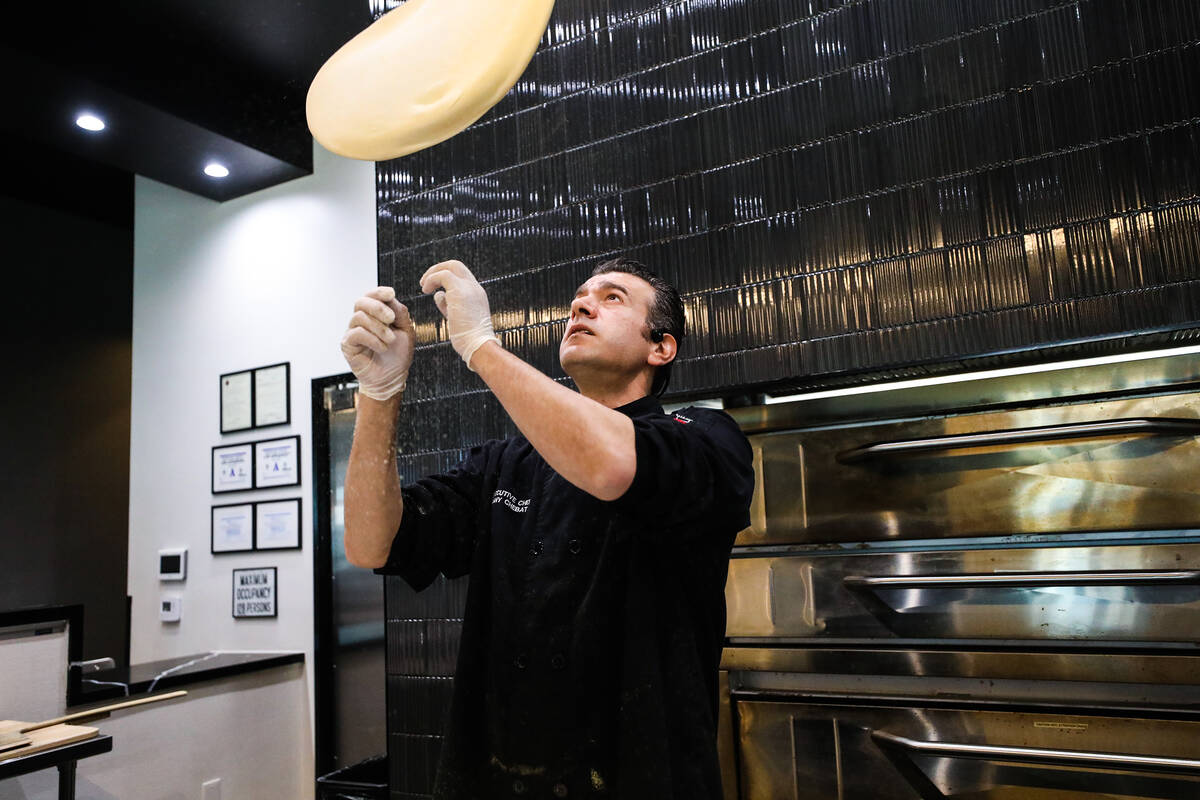 Executive chef Dany Chebat tosses dough for the parma pizza pie at Crust & Roux in Las Vegas, W ...