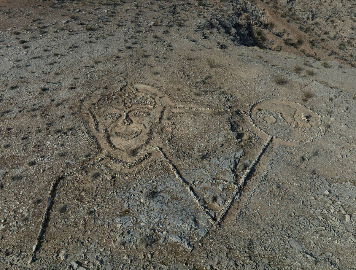 Rocks arranged by an unknown person in the shape of a large triangle with a yin yang at one poi ...