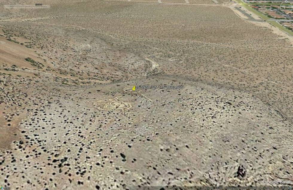 The triangle with the face and yin and yang symbol are there in May 2019. (Google Earth Pro)