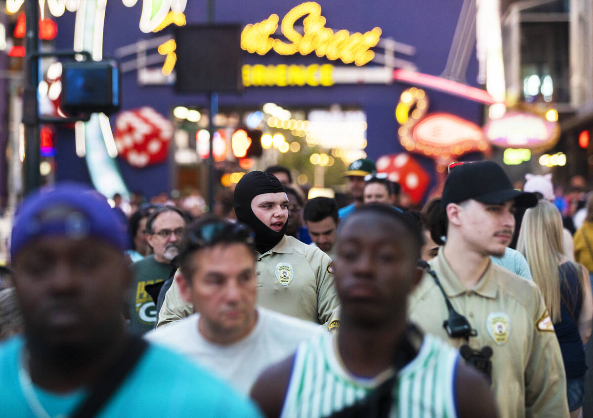 Security officers patrol the Fremont Street Experience on Saturday, July 9, 2022, in Las Vegas. ...