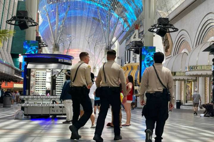 Security guards patrol at the Fremont Street Experience on Friday, July 8, 2022, in downtown La ...