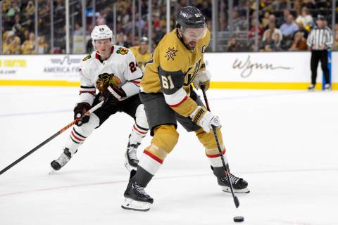Golden Knights right wing Mark Stone (61) breaks away with the puck while Blackhawks center Sam ...
