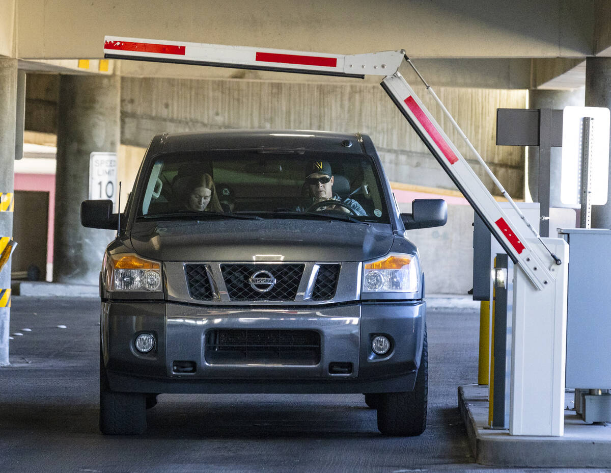 Passengers enter the level 2 of Terminal 1 parking lot at Harry Reid international Airport, on ...