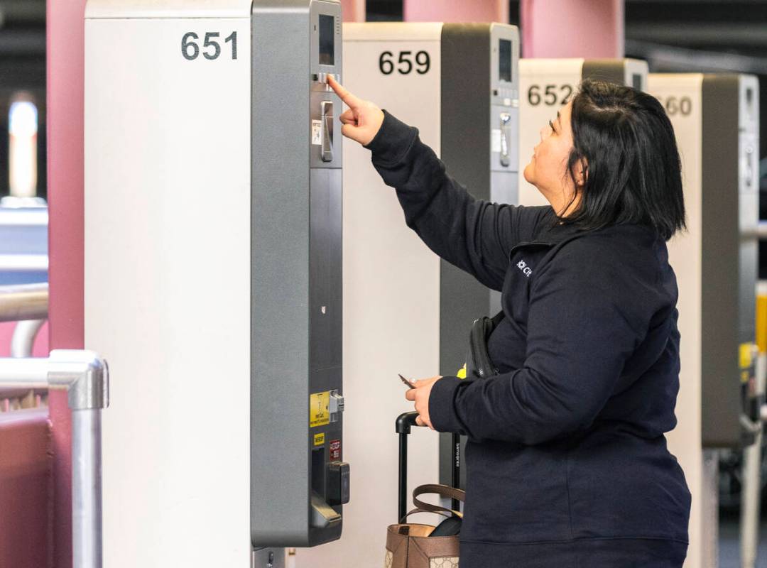 An arriving passenger pays her parking fee at the level 2 of Terminal 1 parking lot at Harry Re ...