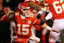 Kansas City Chiefs quarterback Patrick Mahomes (15) tries to escape pressure from the Cincinnat ...