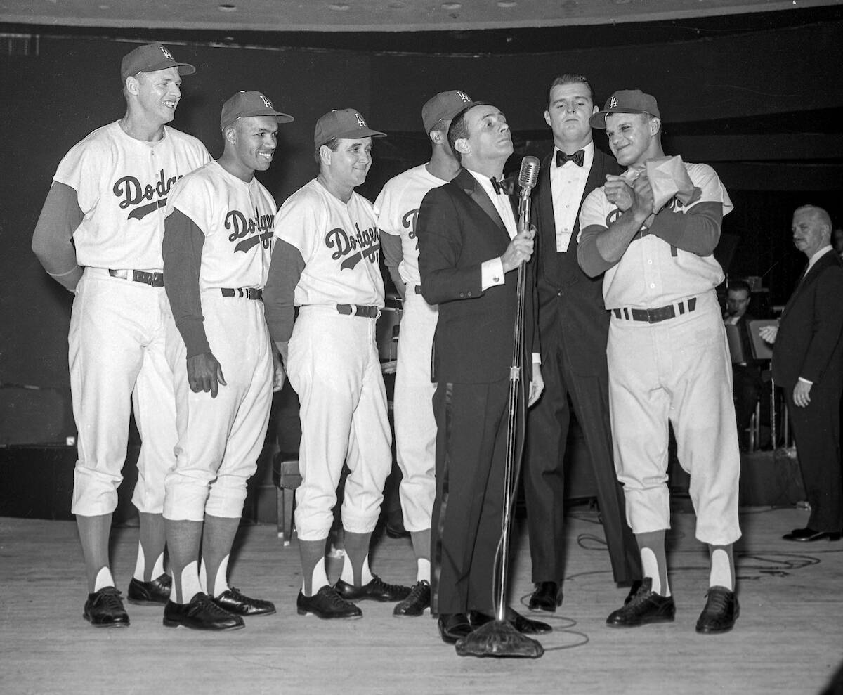 Joey Bishop performs on stage with Los Angeles Dodgers, from left, Frank Howard (25), Tommy Dav ...