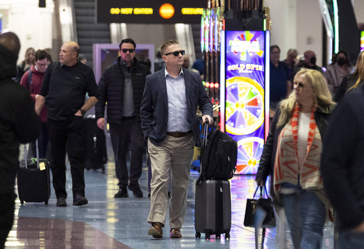 People arrive to the baggage claim area of Terminal 1 at Harry Reid International Airport in La ...
