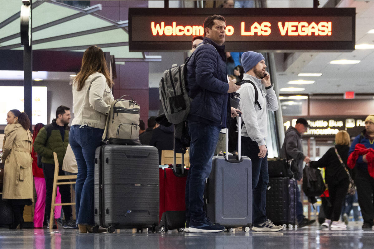 People arrive to the baggage claim area of Terminal 1 at Harry Reid International Airport in La ...