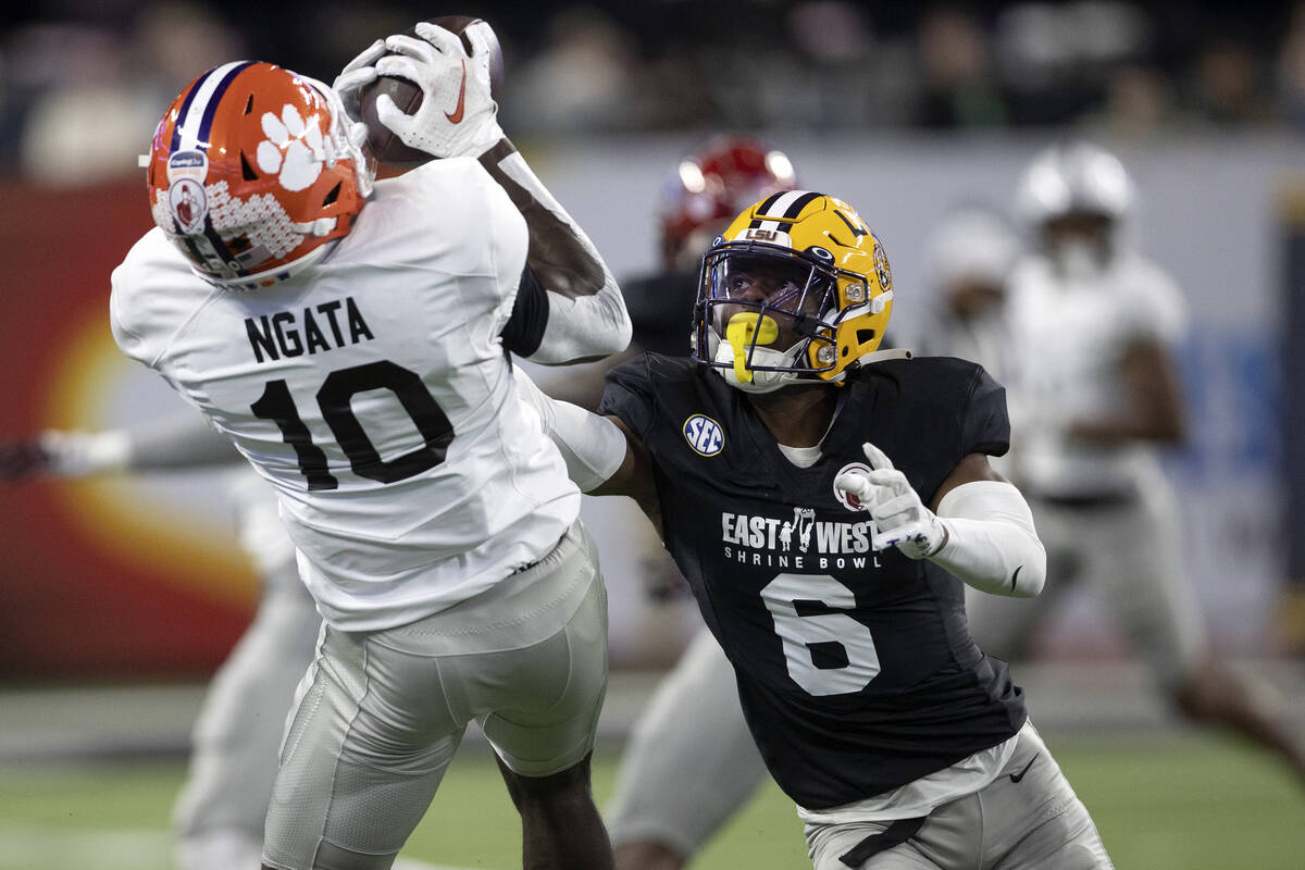 East wide receiver Joseph Ngata, of Clemson, attempts to catch a pass while West cornerback Jar ...