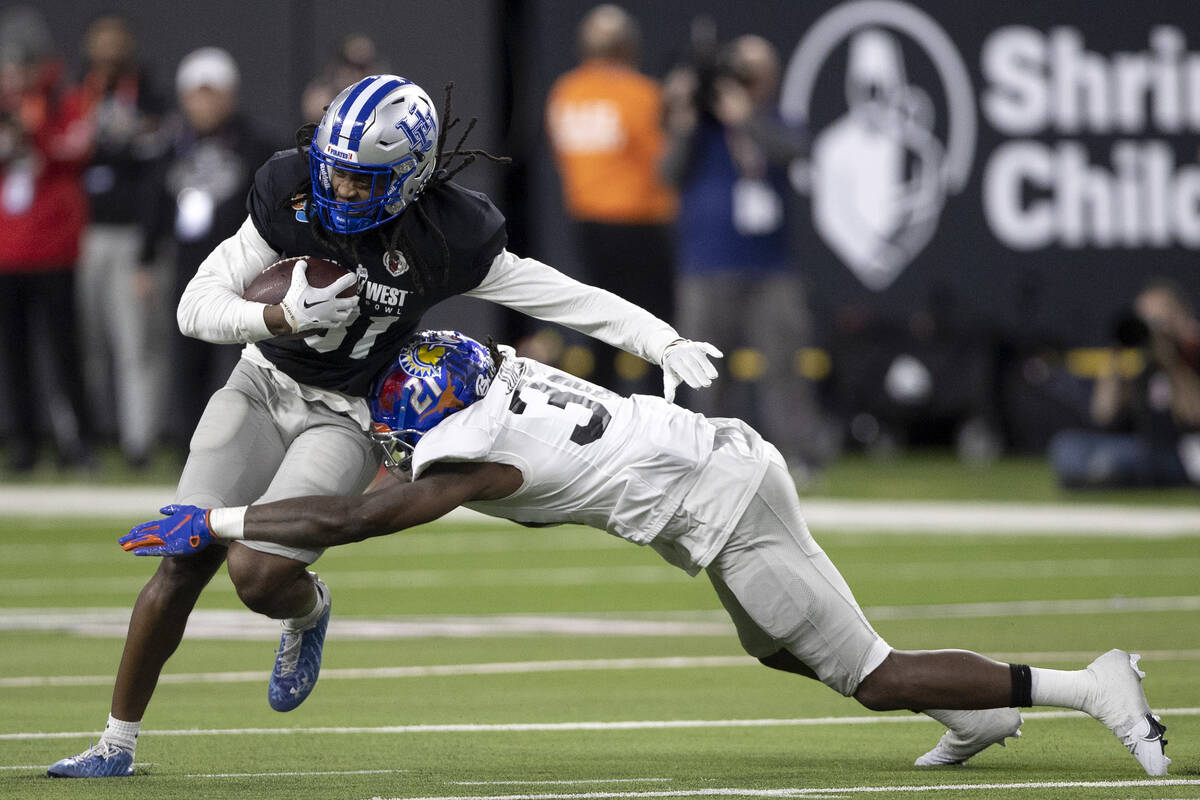 East safety Tyreque Jones, of Boise State, tackles West wide receiver Jadakis Bonds, of Hampton ...