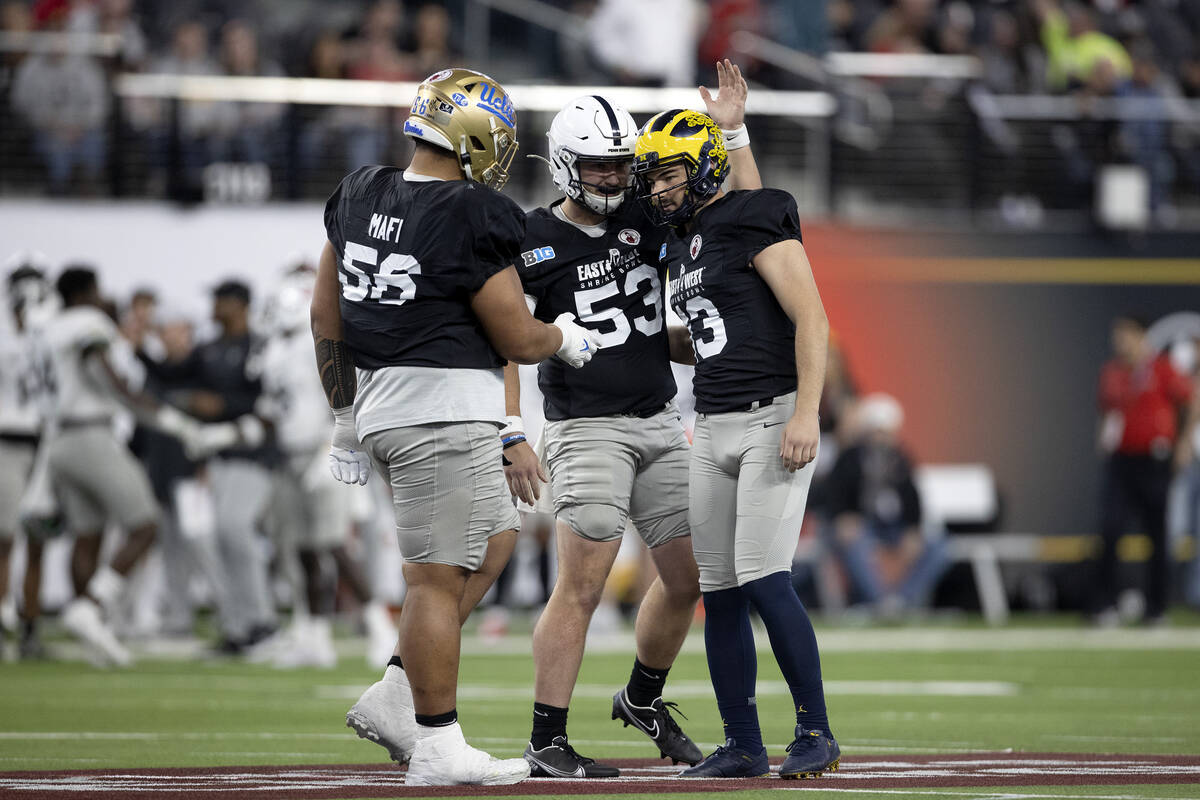 West kicker Jake Moody of Michigan (13) is congratulated by offensive lineman Atonio Mafi of UC ...